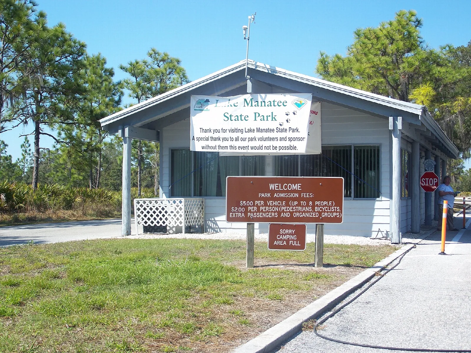 Small ranger station with a porch and park sign