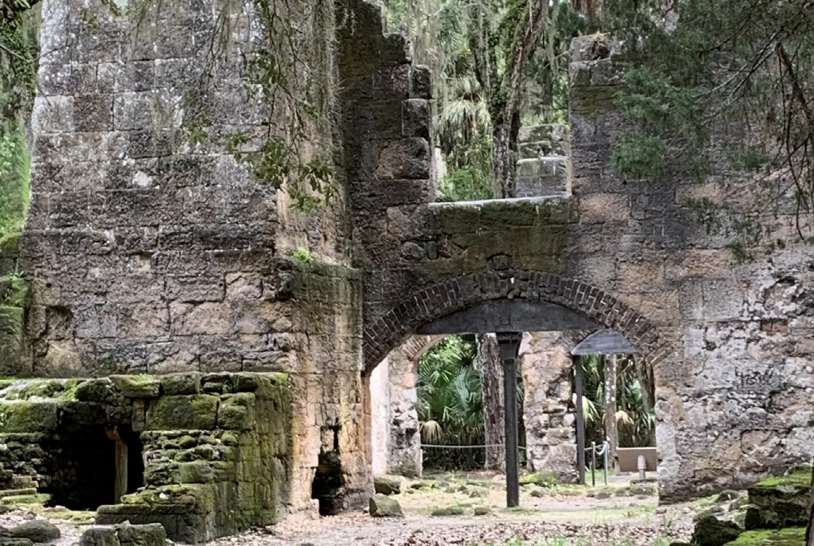 Mossy stone walls and arches of the old mill
