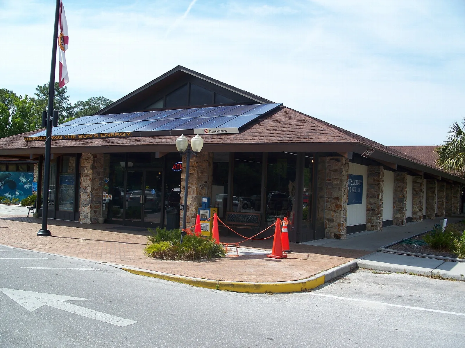 Brick visitor center with a solar roof and flag