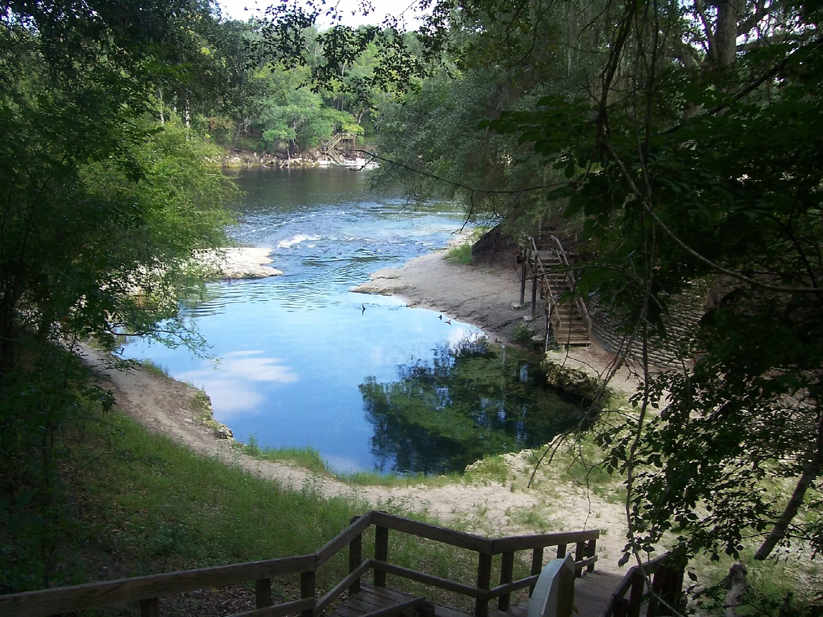River bend seen from a wooden stairway among trees