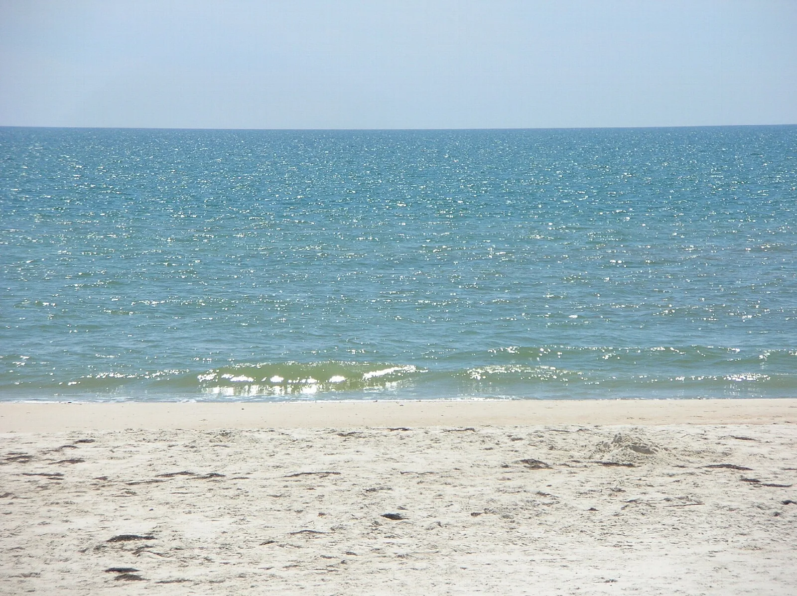 Gentle surf on a pale sand beach