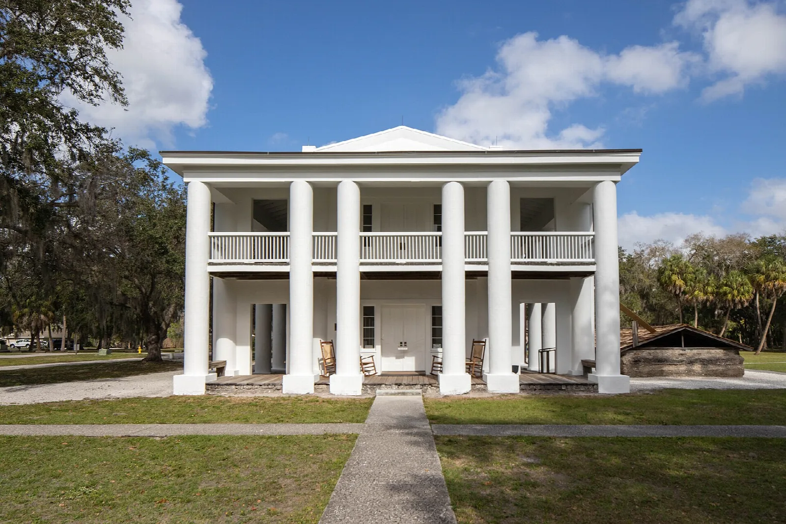 White-columned plantation mansion seen from the front across a lawn