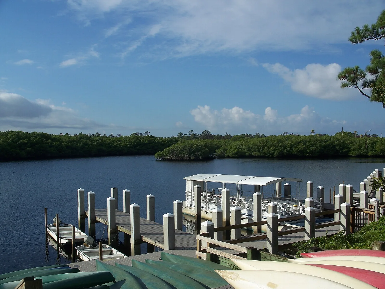 Boat dock and kayaks on a wide river