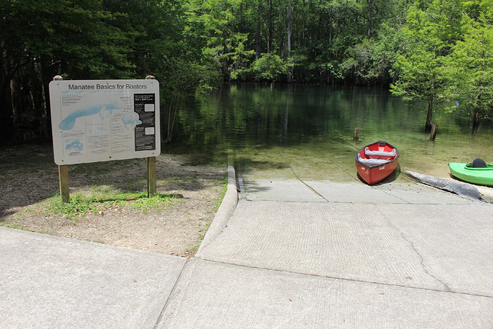Concrete boat ramp with kayaks at the water