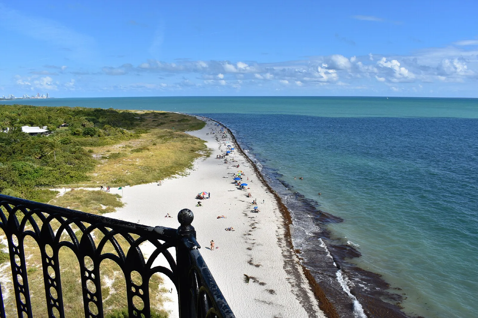 Curving white beach and turquoise sea seen from the lighthouse