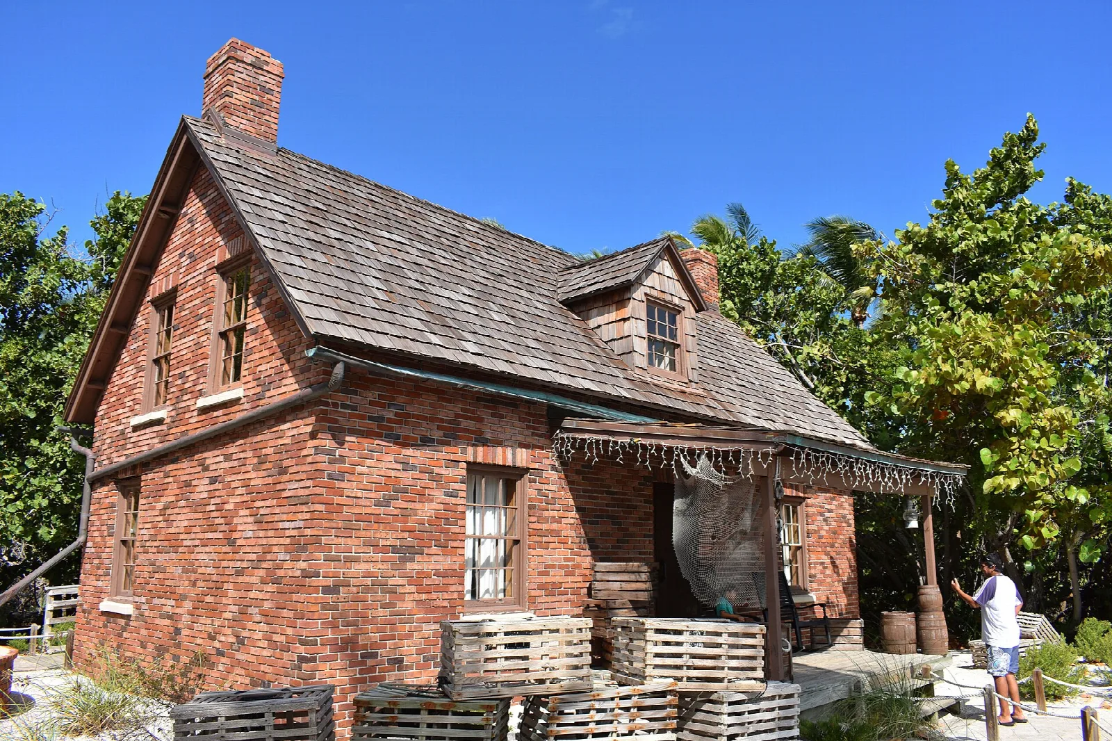 Old brick keeper's cottage with a shingle roof