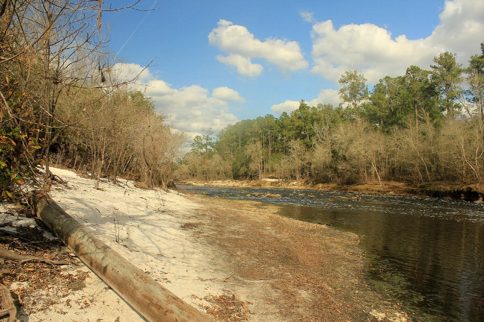 Concrete boat ramp running into a brown river