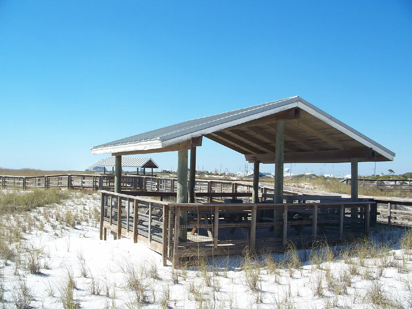 Wooden pavilion on white dunes with sea oats