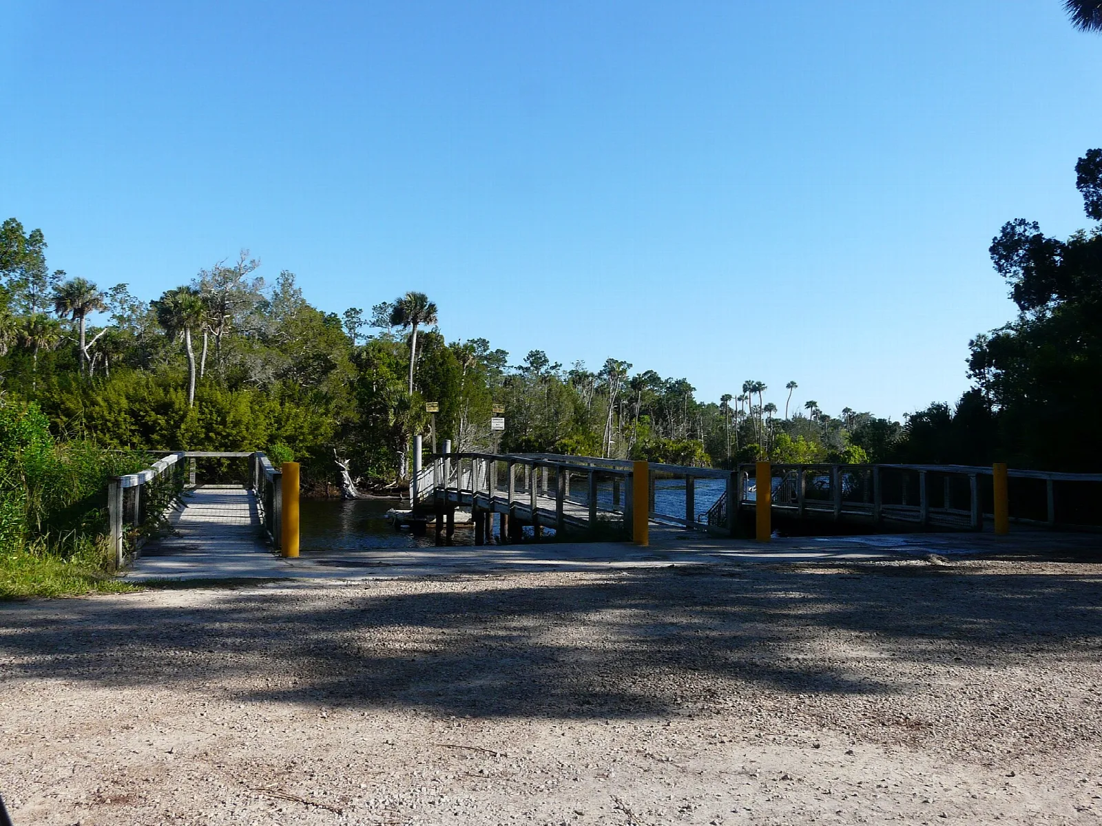 Boat launch area with a wooden pier near trees