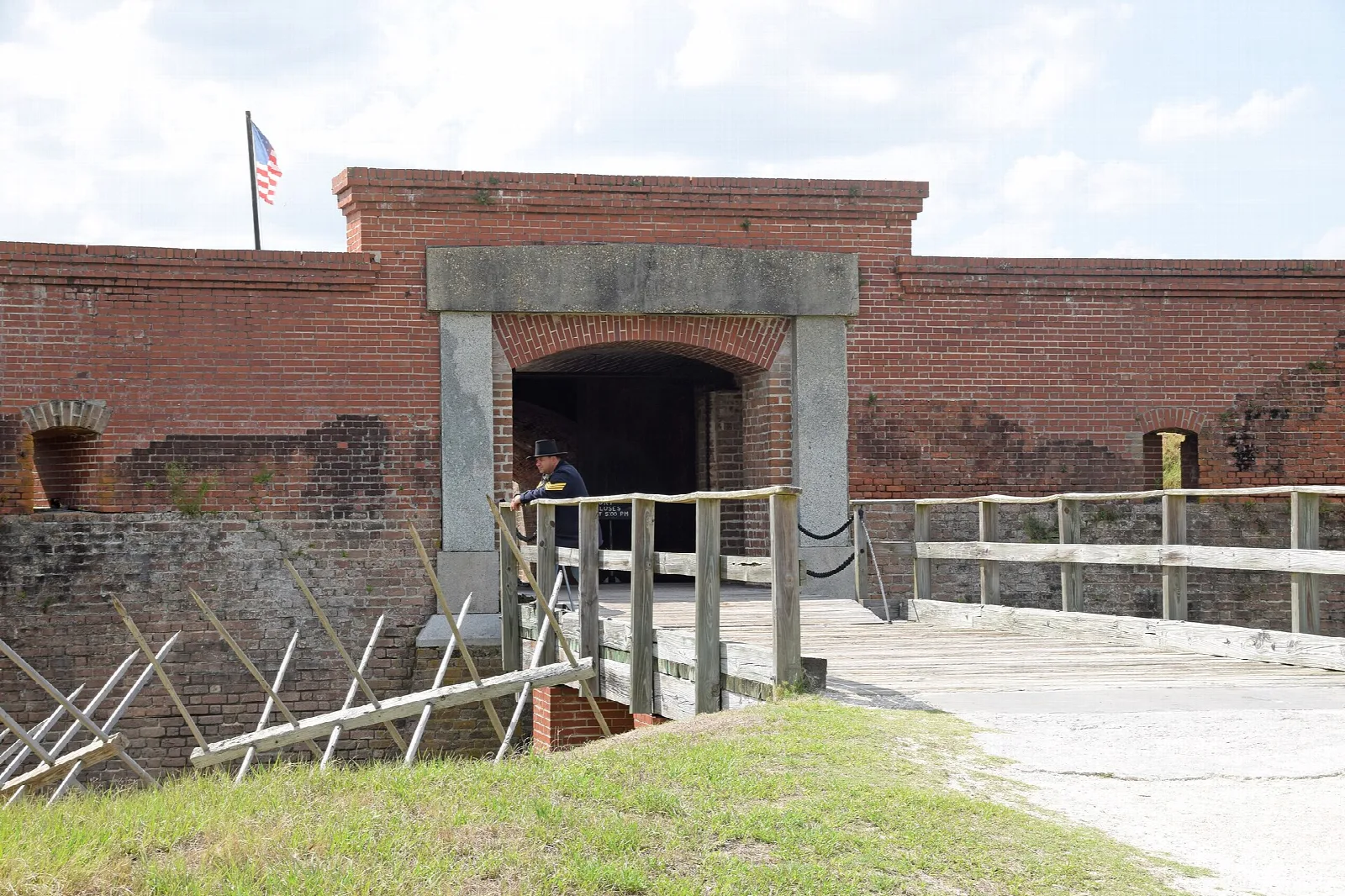 Brick fort entrance reached by a footbridge over the moat