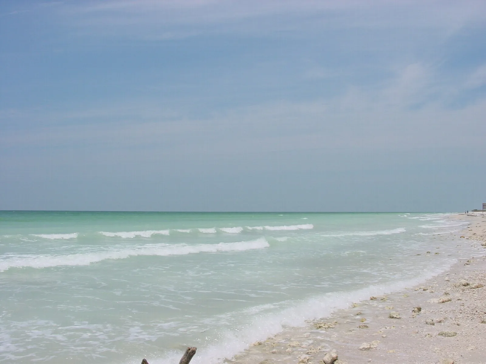 Turquoise water and gentle surf on a pale beach