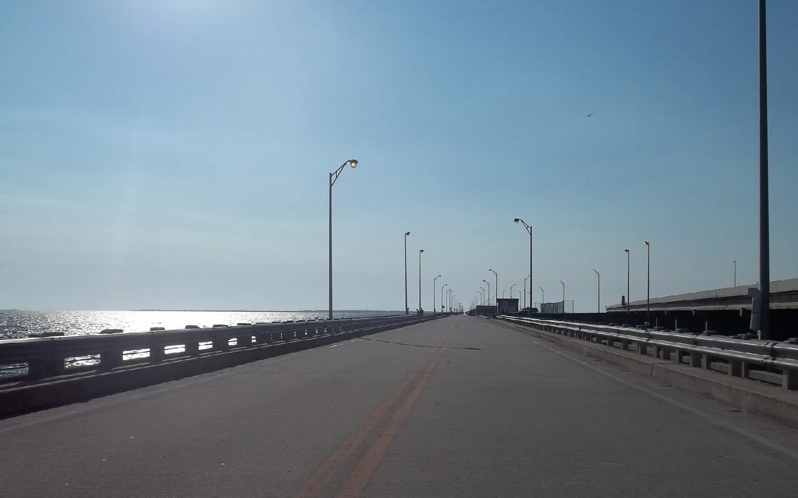 Pier roadway with light poles stretching toward the bay