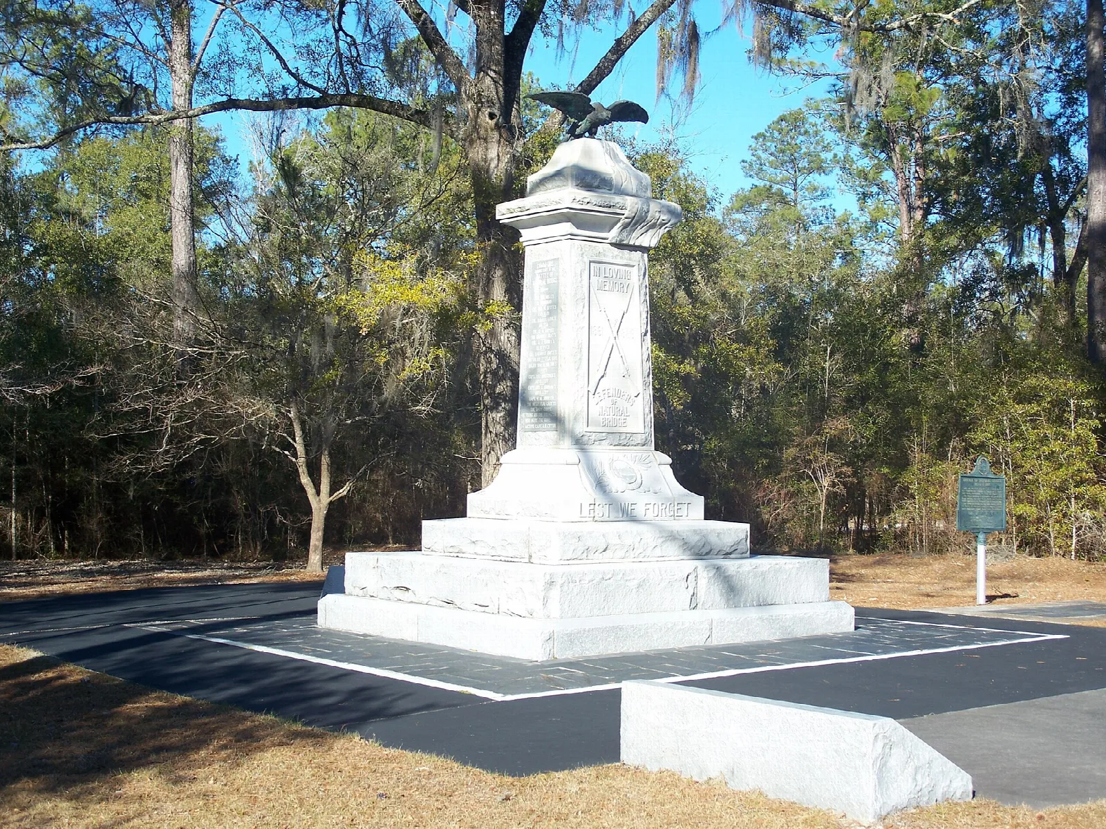 White stone monument in a clearing among oaks