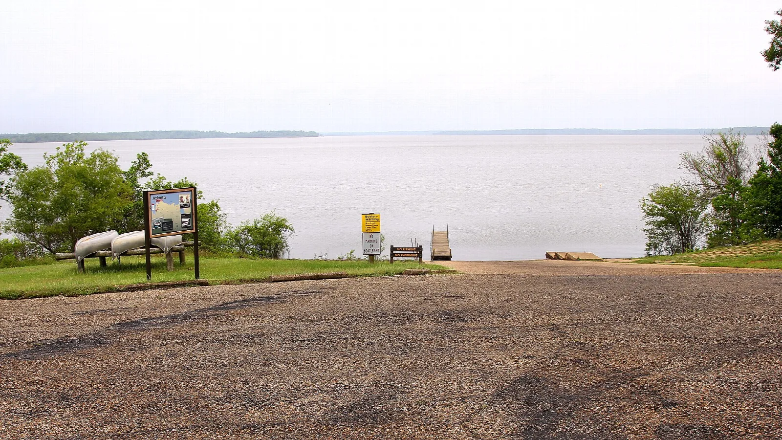 Gravel boat ramp sloping to a wide lake