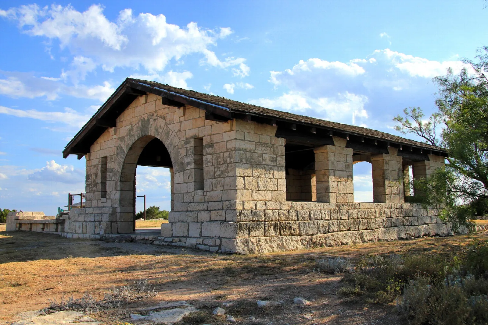 Stone pavilion with an arched opening and tile roof