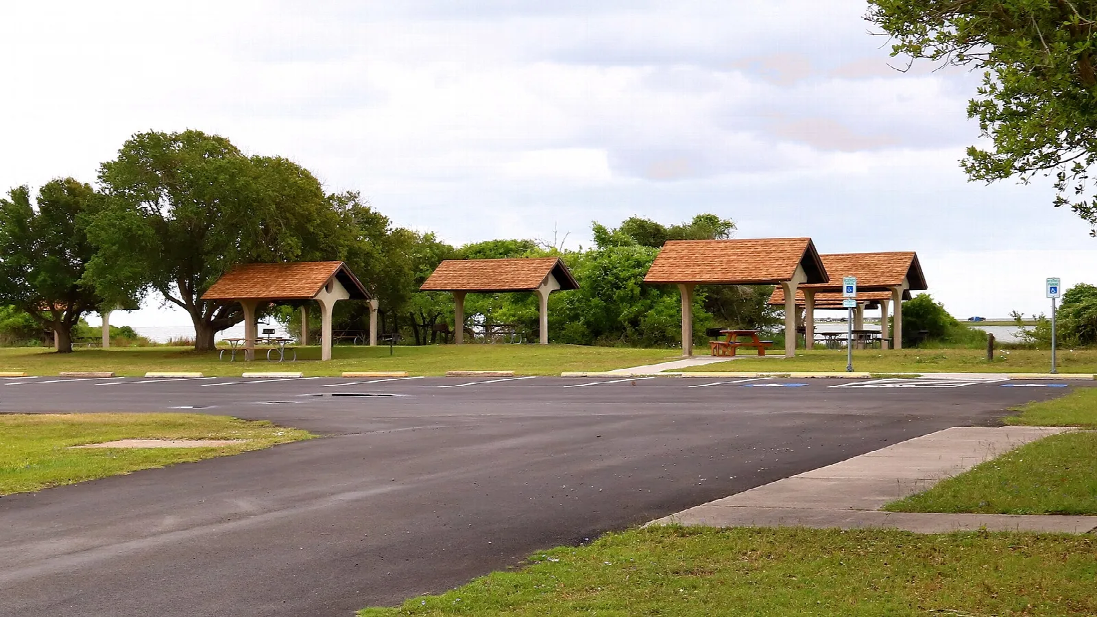 Open day use area with picnic shelters and a paved lot