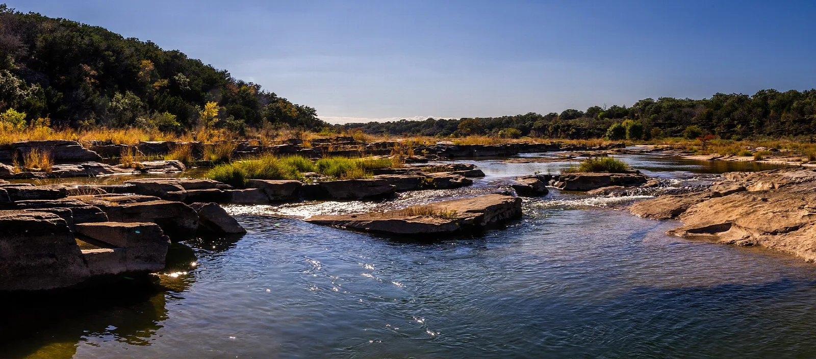 River flowing past rock ledges at dusk