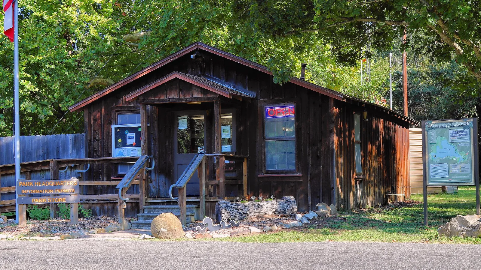 Rustic wooden park office with porch and information boards