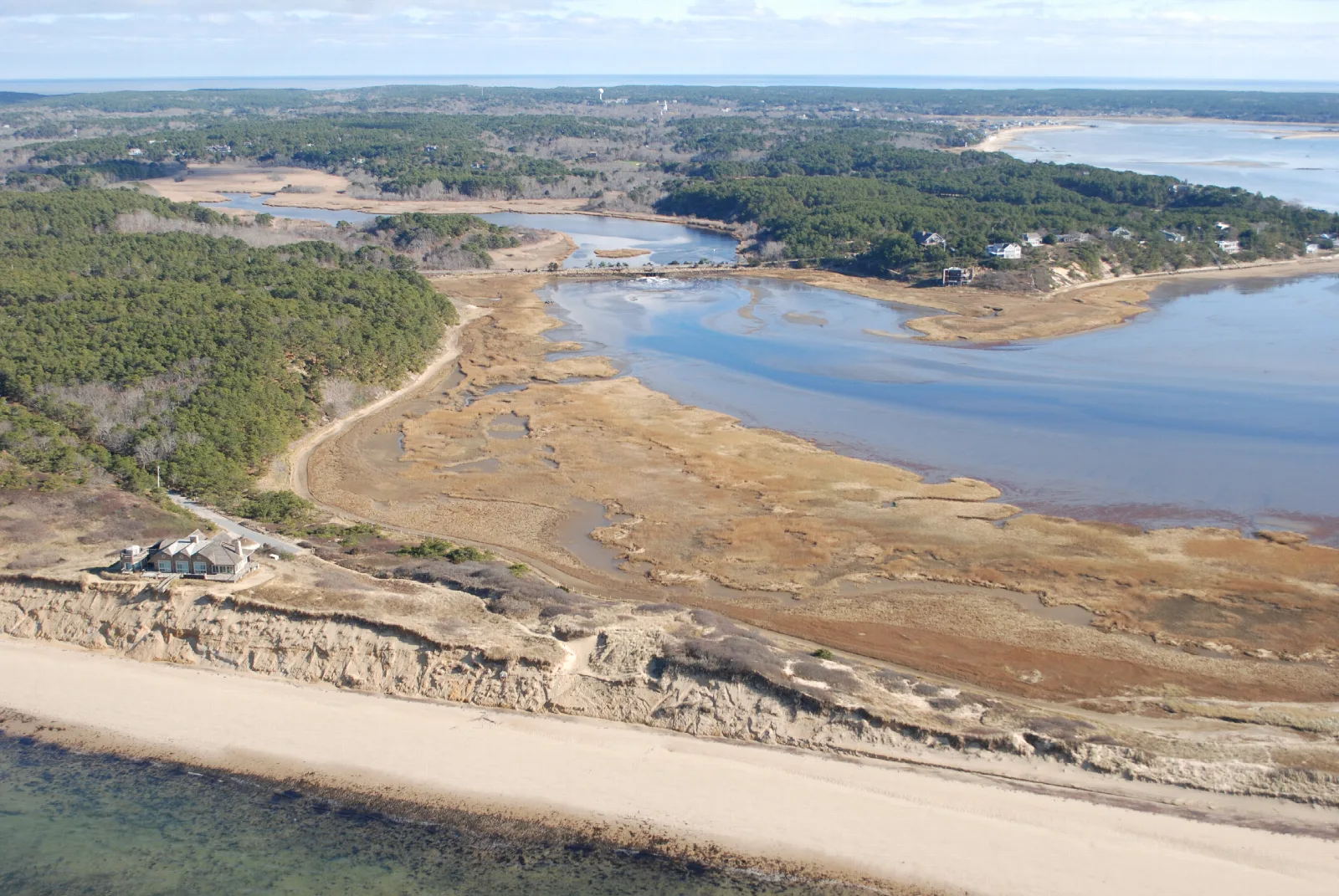 Aerial view of the start of the Great Island Trail, beach surrounded by ocean and a cove.